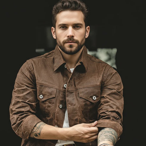 Man wearing a brown jacket with a blurred background