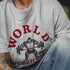 Person wearing a gray t-shirt with a graphic design of a weightlifter and 'World Weightlifter' text.
