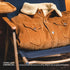 Brown corduroy jacket with beige fleece lining on a blue chair