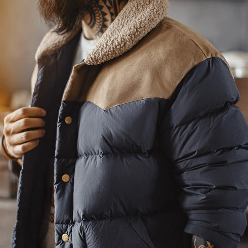 Person wearing a two-tone puffer jacket with a blurred background