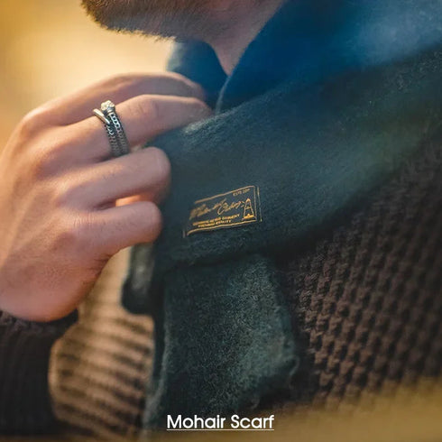 Person wearing a branded mohair scarf with a blurred background