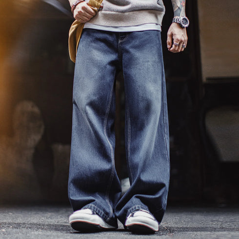 Person wearing wide-leg jeans and sneakers on a blurred background