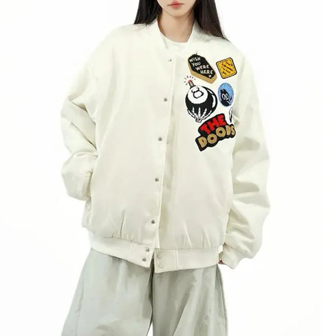 White bomber jacket with colorful graphics and text worn by a person on a white background
