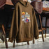 Brown hoodie with colorful patches on a wooden chair