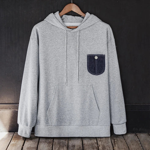 Men's casual denim pocket-spliced hoodie with hood and front pockets, made of cotton and polyester blend.