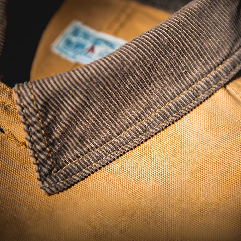 Close-up of a brown fabric with a label on a dark background