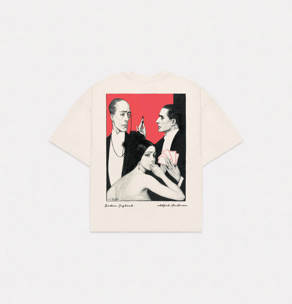 An off-white short-sleeve t-shirt with a large graphic print on the back, featuring a black and red illustration of three figures with the text 'Surreal, England' and 'Witless Aesthetician' printed below.